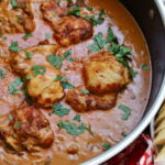 Chicken Paprikash in skillet with herbs